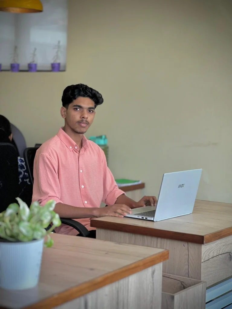A best freelance digital marketing consultant in Malappuram sitting and using laptop